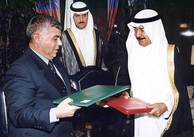 Syrian Prime Minister Mohammed Mustafa Miro (L) and his Bahraini counterpart Khalifa bin Salman al-Khalifa (R) exchange a cooperation agreement they signed in Manama 21 September 2000. The two countries are set to increase cooperation in all fields with the establishment of a joint commission, according to a statement issued by the two sides before Miro left Bahrain, at the end of a 24-hour visit to the Gulf emirate. (Photo by GNA / AFP)