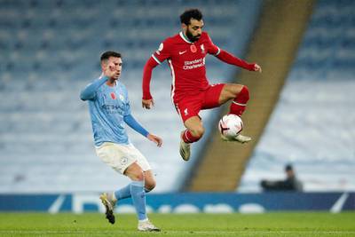 Liverpool's Mohamed Salah controls the ball, watched by City defender Aymeric Laporte. AP