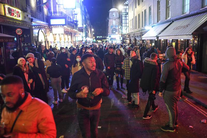 People are seen after restaurants and bars shut in Soho. Getty Images