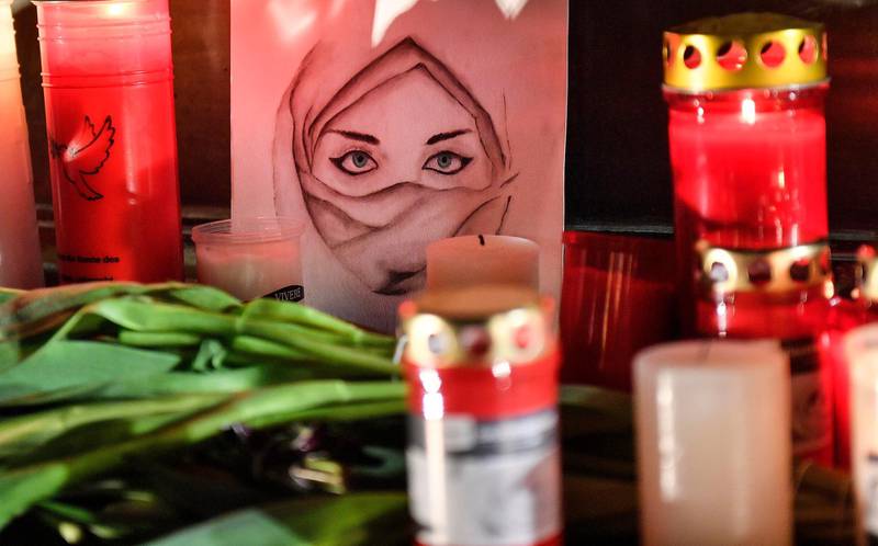 A picture of a woman is seen between candles and flowers at a monument on the market place during mourning for the victims of the shooting in Hanau, Germany. A 43-year-old German man who posted a manifesto calling for the "complete extermination" of many "races or cultures in our midst" shot and killed several people of foreign background on Wednesday night, most of them Turkish, in an attack on a hookah bar and other sites in a Frankfurt suburb, authorities said Thursday. AP Photo