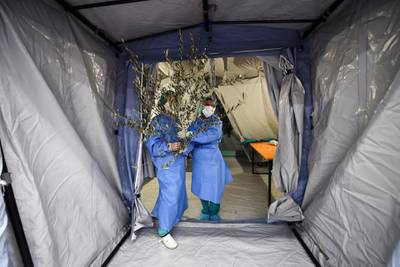 Members of the medical staff hold palm tree branches at the emergency unit of the Molinette Hospital on Palm Sunday, during the coronavirus disease (COVID-19) outbreak, in Turin, Italy. REUTERS