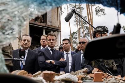 Italian Prime Minister Mario Draghi, left, and French President Emmanuel Macron won a visit to Irpin, outside Kyiv.  The leaders of France, Germany, Italy and Romania arrived in Kyiv on Thursday in a show of collective European support for the Ukrainian people as they resist Russia's invasion. AP