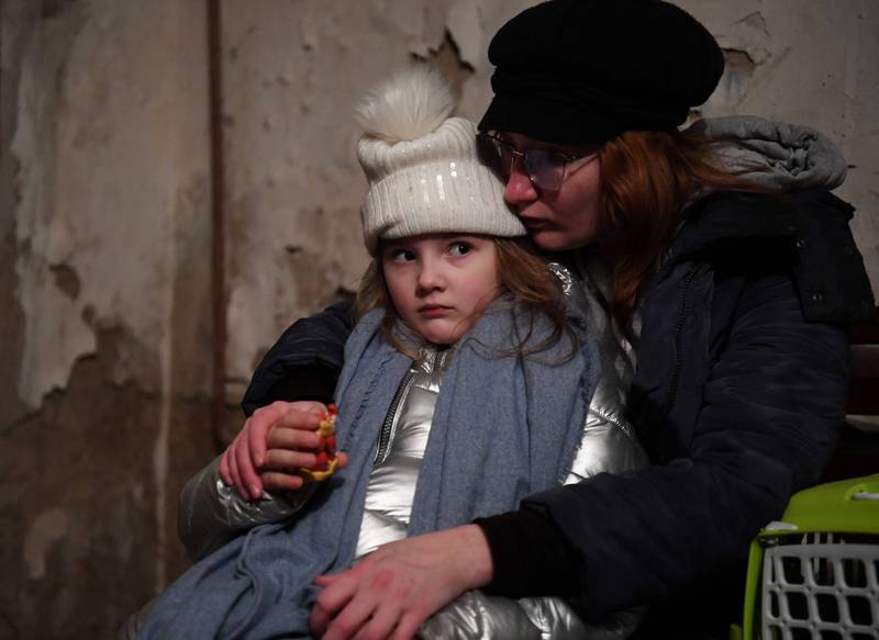 Helga Tarasova comforts her daughter Kira Shapovalova as they wait in an underground shelter during a bombing alert in Kiev. AFP