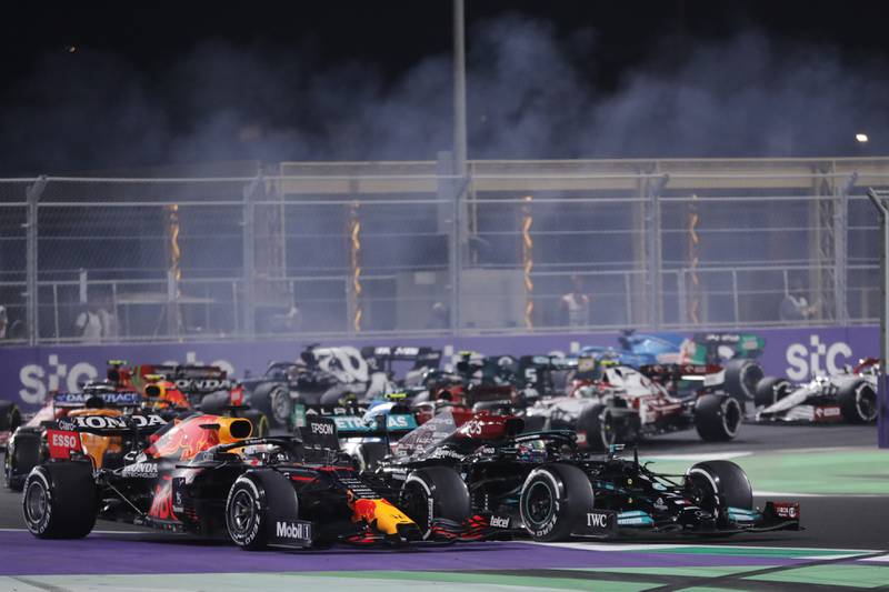 Max Verstappen and Lewis Hamilton compete for the lead. AP
