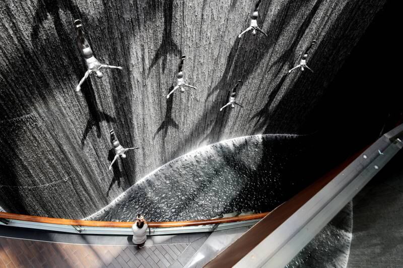 Dubai, United Arab Emirates - July 20, 2019: Standalone. A visitor takes pictures of The Dubai Mall Waterfalls. Saturday the 20th of July 2019. Downtown, Dubai. Chris Whiteoak / The National
