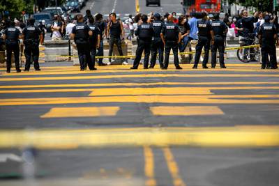 Demonstrators stand in front of a police line as a section of 16th Street that has been renamed Black Lives Matter Plaza has been closed to pedestrians, Wednesday, June 24, 2020, in Washington. The area has been the site of protests over the death of George Floyd, a black man who was in police custody in Minneapolis. Floyd died after being restrained by Minneapolis police officers. (AP Photo/Jacquelyn Martin)