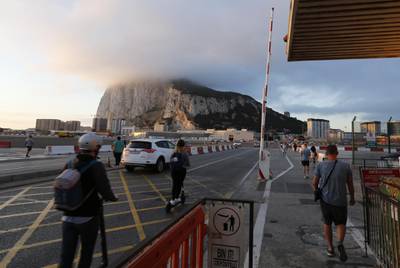 Pedestrians pass through the border crossing with Spain into Gibraltar, on Thursday, Sept. 26, 2019. With the U.K.’s European Union exit date just four weeks away and no deal in sight to ensure smooth connections with the Spanish mainland, Gibraltar has been thrown into disarray. Photographer: Marcelo del Pozo/Bloomberg