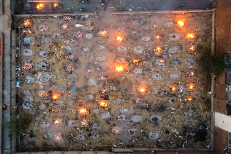 Funeral pyres of people who died of Covid-19 burn at a cremation ground in New Delhi, on April 26. AFP