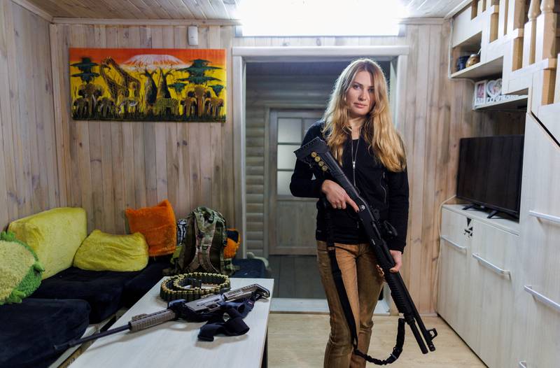 Alisa poses with a gun at her home near Kiev. Reuters