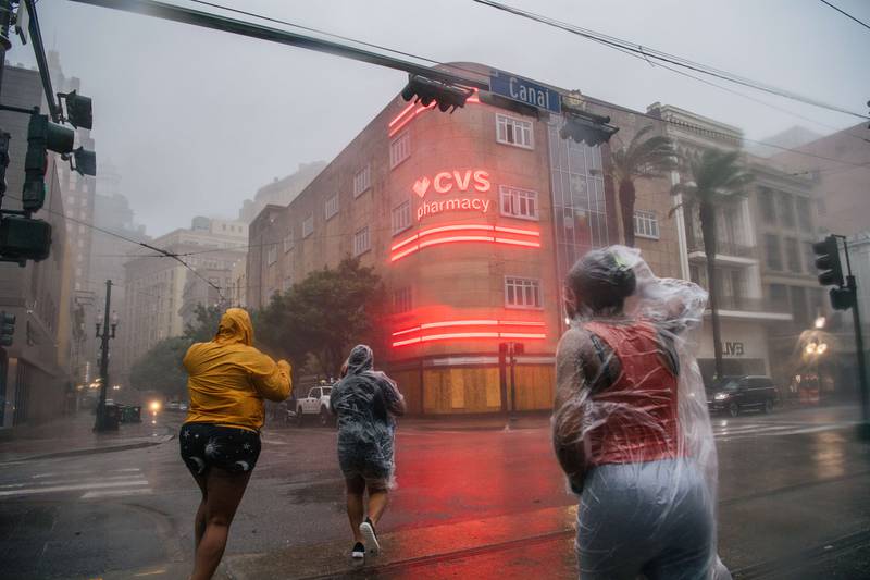 People cross an intersection during Hurricane Ida in New Orleans. AFP
