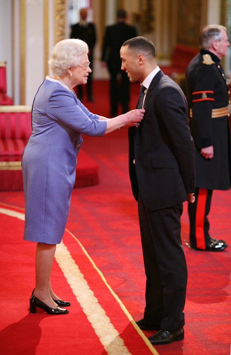 British boxer James Degale is presented with an MBE by Queen Elizabeth II in 2009. PA