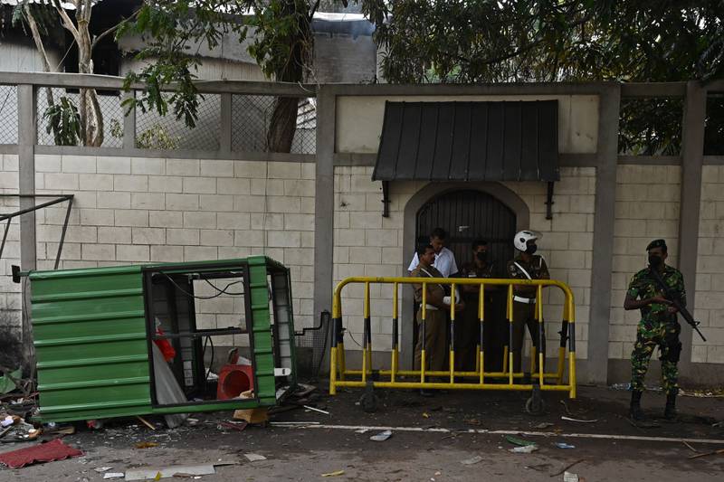 Security personnel guard the home of Sri Lankan Prime Minister Ranil Wickremesinghe in Colombo on Sunday, a day after protesters set it on fire. Photo: AFP