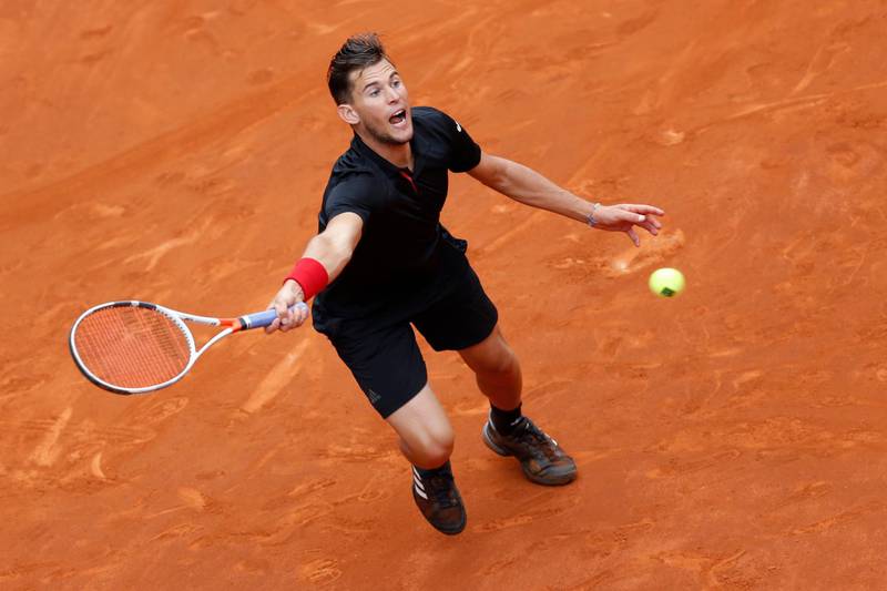 Austria's Dominic Thiem from Austria returns a ball from South Africa's Kevin Anderson during a Madrid Open tennis tournament semi final match in Madrid, Spain, Saturday, May 12, 2018. Thiem won 6-4 and 6-2. (AP Photo/Francisco Seco)