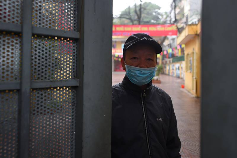 A security staff stands at the entrance of a primary school closed to prevent the spread of corona virus in Hanoi.  AFP