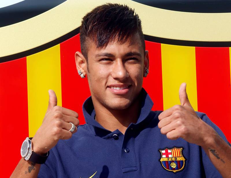 Neymar poses for photographs after completing his transfer from Santos to Barcelona in 2013. Reuters
