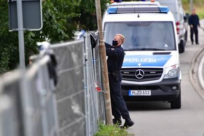 A police officer erects fencing around an allotment that belonged to Christian Brueckner, who was named as the prime suspect in the disappearance of Madeleine McCann, in July 2020 in Hannover, Germany.