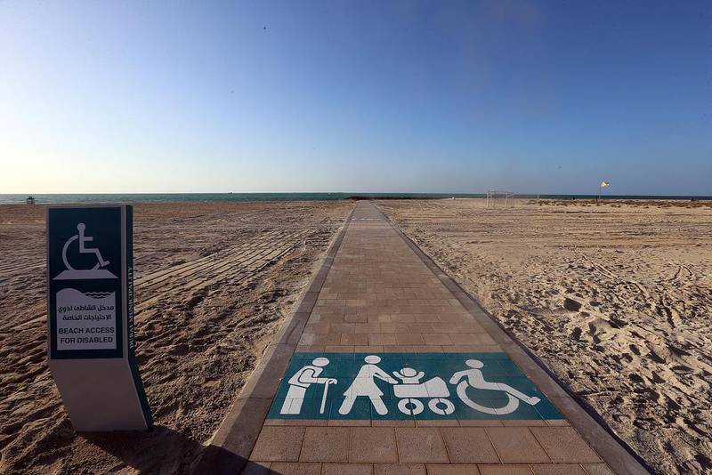 Above, the new wheelchair acessible path at the kite beach in Dubai. A solar-powered mobility kit would cost about Dh1,345, says a research from Bangladesh. Satish Kumar / The National