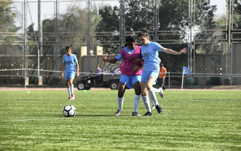 Abu Dhabi, United Arab Emirates - Girls also took part for the first time, Abu Dhabi City team (blue) vs. Adissa (pink) under 14 age group on Abu Dhabi World Cup Day 1 at Zayed Sports City. Khushnum Bhandari for The National
