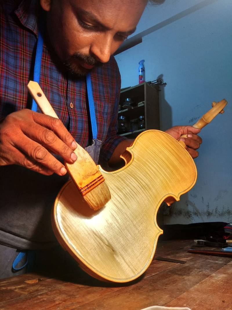 Renjith Leela Chandran at his work desk, crafting a violin from scratch. Photo: Renjith Leela Chandran 