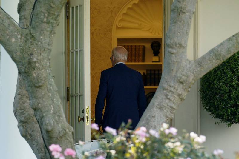 Mr Biden enters the Oval Office of the White House. Bloomberg