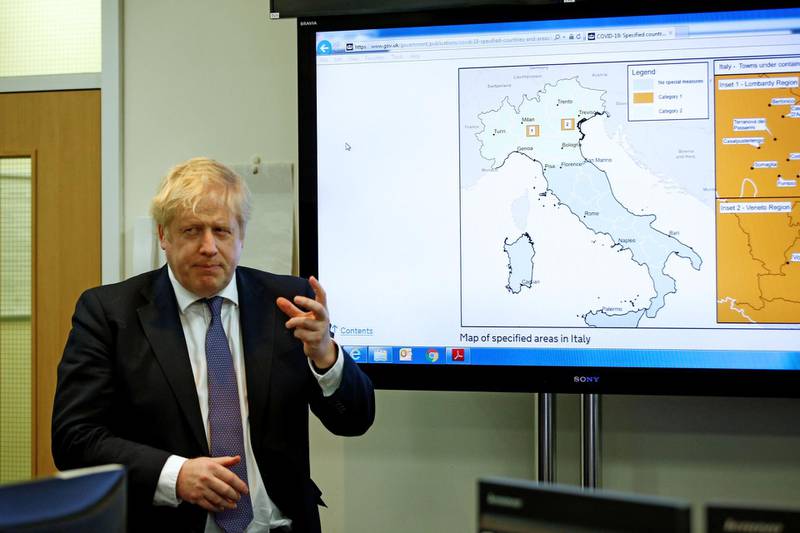 Britain's Prime Minister Boris Johnson gestures in front of a map of Italy in the command centre during a visit to the Public Health England National Infection Service in Colindale in north London on March 1, 2020. / AFP / POOL / HENRY NICHOLLS

