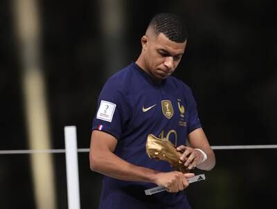 Kylian Mbappe of France with his Golden Boot award for finishing as the tournament's top scorer. EPA