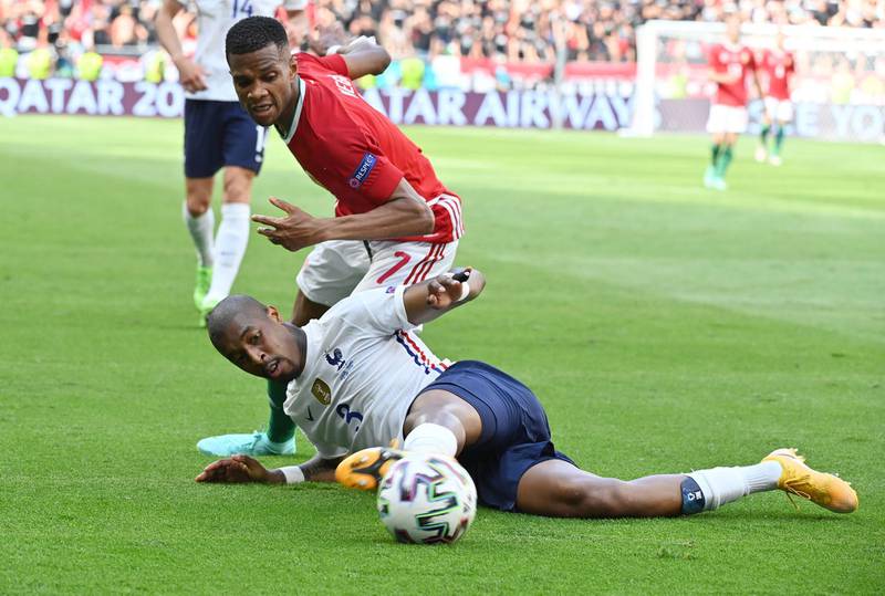 France's Presnel Kimpembe under pressure from Loic Nego of Hungary. Reuters