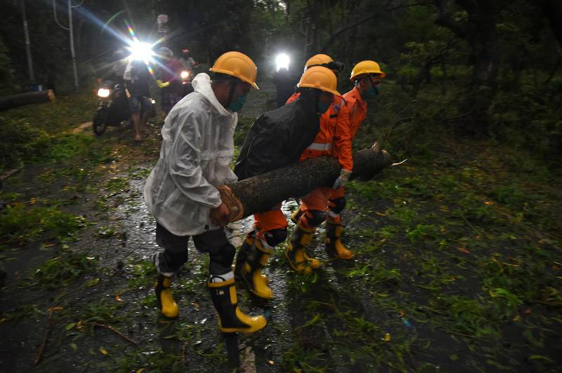 Members of National Disaster Rescue Force remove a branch of an uprooted tree after cyclone Amphan made its landfall, in Digarh near the border between the eastern states of West Bengal and Odisha, India. Reuters