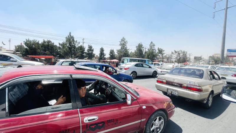 Families on a motorway trying to flee Kabul.