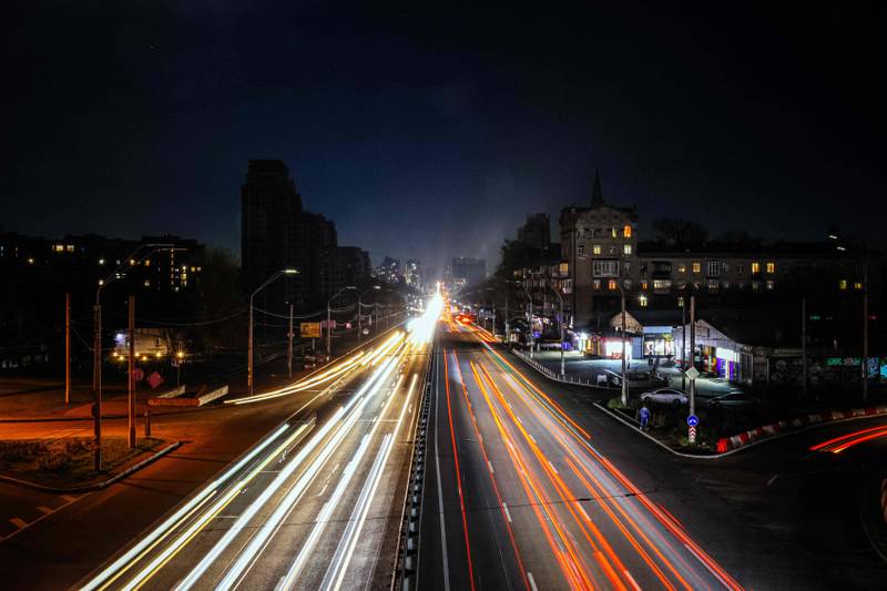 Cars driving at night during a blackout after a military strike partially damaged the electricity infrastructure in Kyiv. AFP



