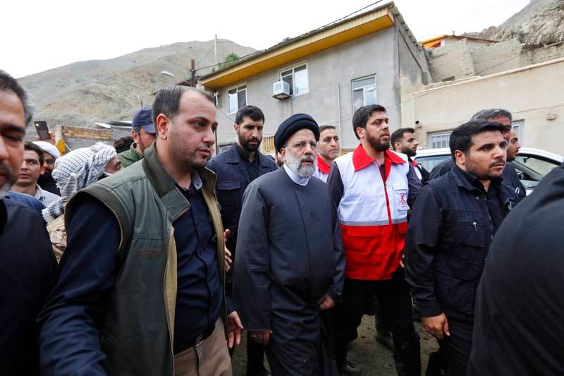 Iranian President Ebrahim Raisi, centre, during his visit to Firuzkuh to assess the flood situation. EPA
