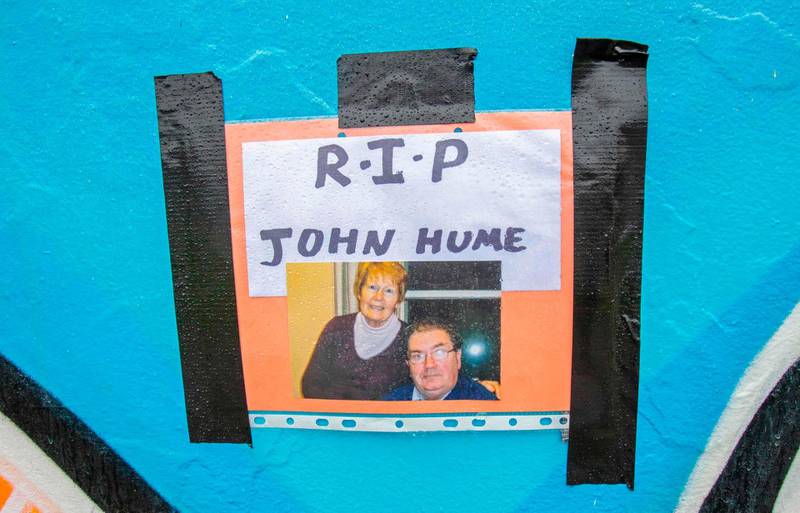 A photograph and message is pictured at the Free Derry wall in the Bogside area for John Hume in Derry. AFP
