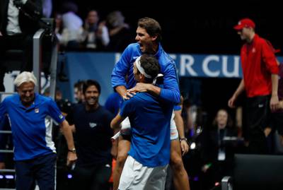 Europe's Roger Federer celebrates with teammate Rafael Nadal, top center, after defeating World's Nick Kyrgios during their Laver Cup tennis match in Prague, Czech Republic, Sunday, Sept. 24, 2017. (AP Photo/Petr David Josek)