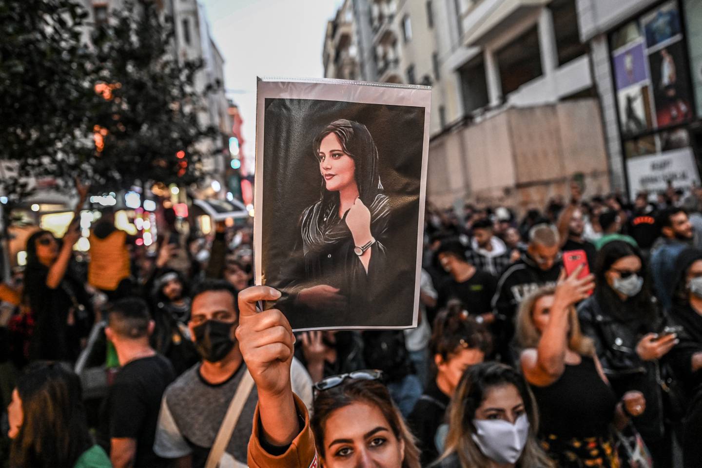 A protester holds a portrait of Mahsa Amini, who died in Iranian morality police custody, in Istanbul. AFP