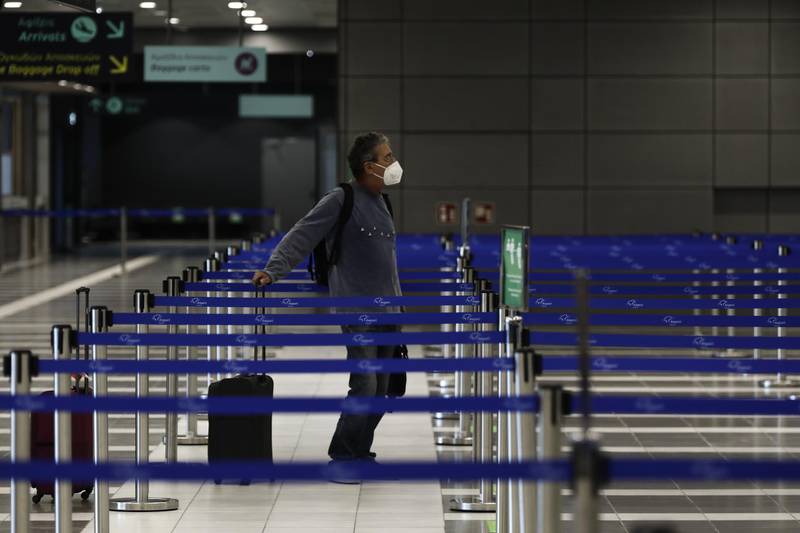 A passenger waits at the check-in at Thessaloniki Makedonia Airport in Thessaloniki, Greece. Bloomberg