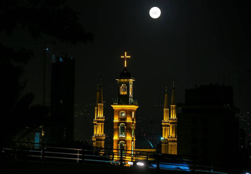 The full moon is seen in the sky over Al-Ameen Mosque and St. Gregory church, Beirut, Lebanon. Nbail Mounzer / EPA