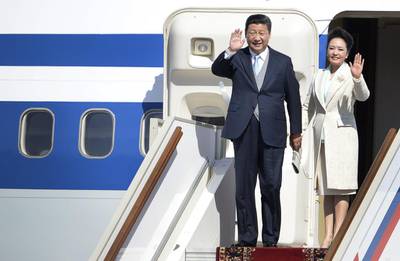 Chinese President Xi Jinping with his wife Peng Liyuan at Moscow's Vnukovo II airport in May. AFP