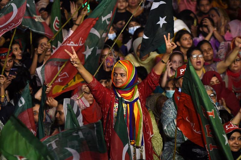 The former cricketer's supporters turned up wearing colourful costumes at the Karachi rally. AFP
