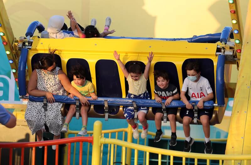 Children enjoy the rides at Global Village.