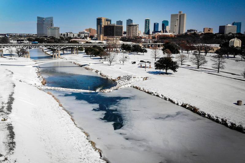 The Trinity River is mostly frozen after a snow storm in Fort Worth. A frigid blast of winter weather across the US has left more than two million people in Texas without power. AP