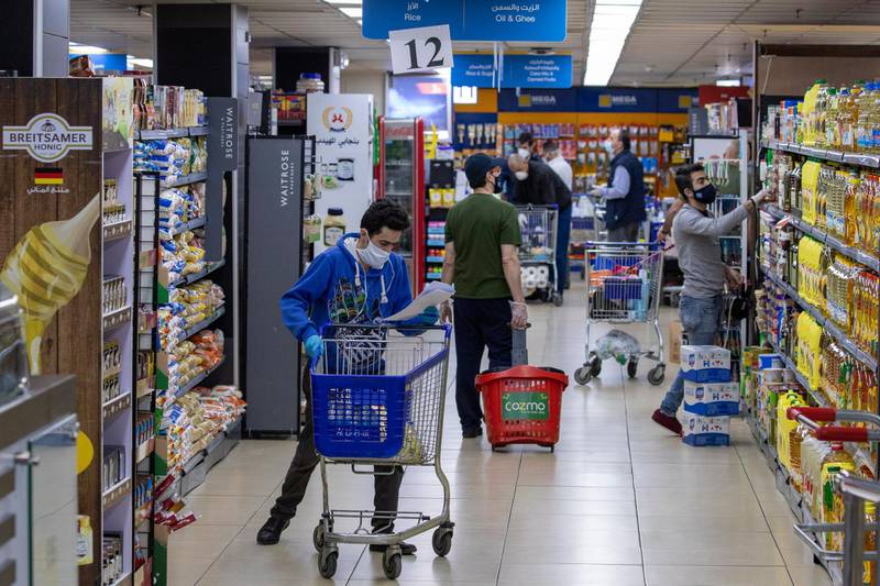 Masked customers and employees are seen at supermarket in Amman, Jordan.  EPA
