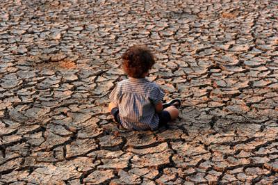 (FILES) In this file photo taken on April 22, 2016 a child remains at an area affected by a drought on Earth Day in the southern outskirts of Tegucigalpa.  Hunger, drought and disease will afflict tens of millions more people within decades, according to a draft UN assessment that lays bare the dire human health consequences of a warming planet.
After a pandemic year that saw the world turned on its head, the Intergovernmental Panel on Climate Change's forthcoming report offers a distressing vision of the decades to come: malnutrition, water insecurity, pestilence.
 / AFP / ORLANDO SIERRA

