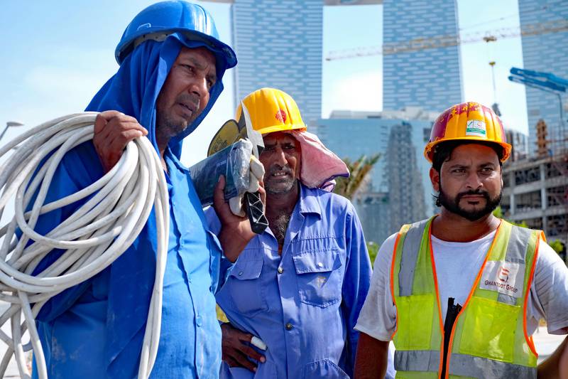 ABU DHABI —— 17 June 2017—— Sukhwant Singh (from left), Ishwar Nath and Vipun Kumar talk about their joy and relief on the start of the midday break for outdoor workers. They all work in construction on Reem Island in Abu Dhabi.  ( DELORES JOHNSON / The National )  *** Local Caption ***  DJ-15-06-17-NA-55555-004.jpg