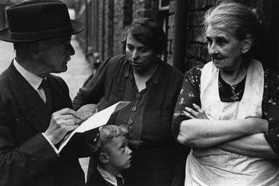People take part in a doorstep survey about the need for a National Health Service in 1944. Getty Images