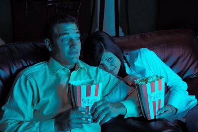 Couple watching movie. Note: Gels were used to achieve effect. 