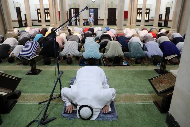Imam Abdul Muhsin Abdul Rahman leads evening prayers at Jumeirah Mosque in Dubai on the day the death of President Sheikh Khalifa was announced. Pawan Singh / The National 