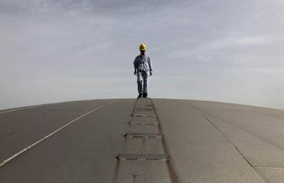An employee walks on top of an oil tank at a Sinopec refinery in Wuhan, Hubei province. China's two big oil firms are on a roll.. Reuters