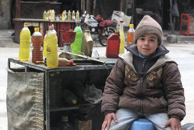 A young boy selling gasoline in Douma. Courtesy of Tim Alsiofi.