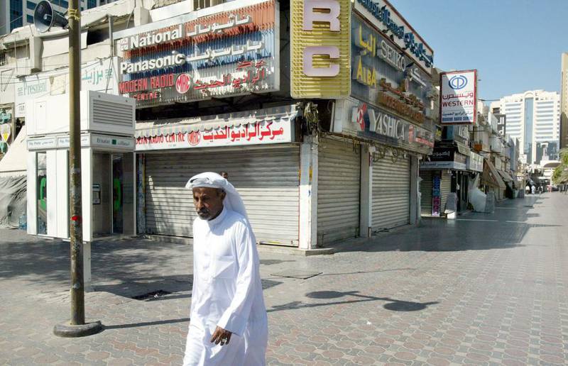 An Emirati walks through deserted street in Abu Dhabi following the death of Sheikh Zayed. Anwar Mirza / Reuters