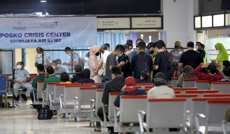 People are seen at a temporary crisis centre organised in the domestic terminal of Soekarno-Hatta International Airport, after Sriwijaya Air plane flight SJ182 lost contact after taking off, in Tangerang, near Jakarta, Indonesia.  REUTERS